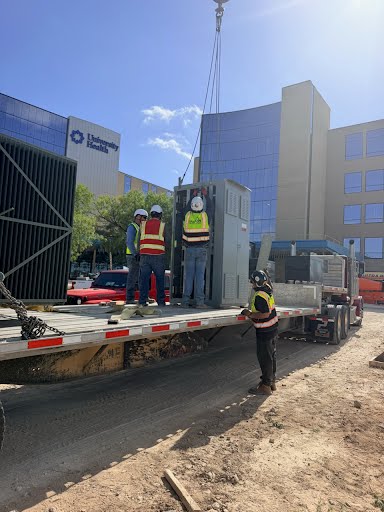 Easton crew rigging a unit onto a flatbed outside University Health Hospital San Antonio